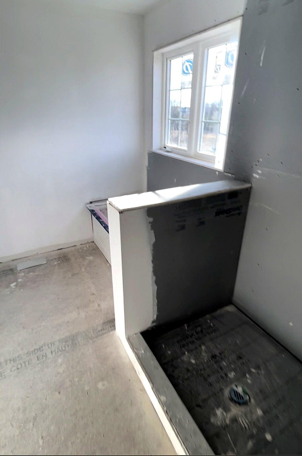 Bathroom before renovation — stripped back to bare walls
